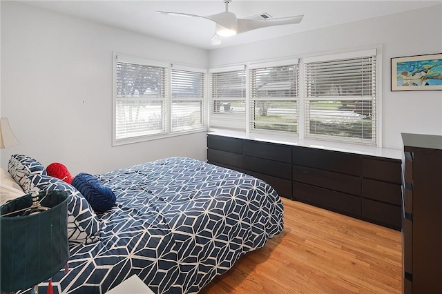 1013 Winding Rd, College Station, TX 77840 - bedroom featuring ceiling fan, light wood finished floors, and multiple windows