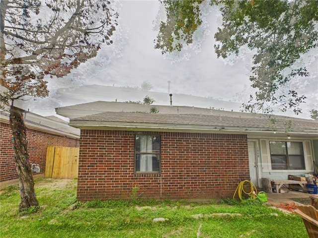 1008 Bittle Ln, Bryan, TX 77803 - view of property exterior featuring brick siding and roof with shingles