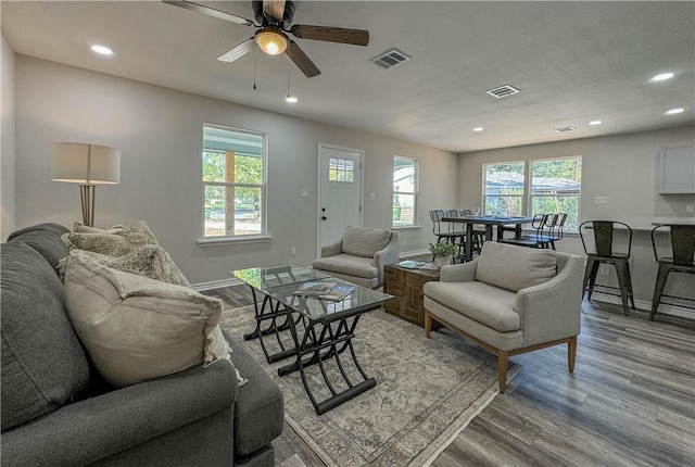 living room featuring visible vents, wood finished floors, and recessed lighting