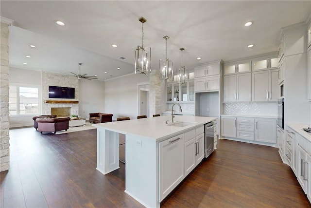 7844 Mathis Creek Dr, Bryan, TX 77808 - kitchen with stainless steel dishwasher, black oven, glass insert cabinets, ceiling fan, and a sink