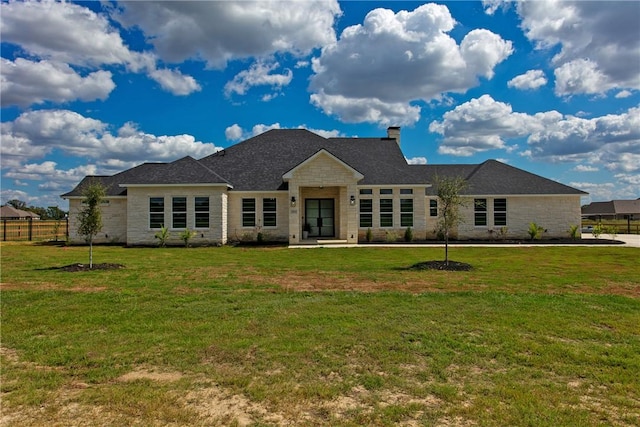 7844 Mathis Creek Dr, Bryan, TX 77808 - back of house featuring a yard, a chimney, and stone siding