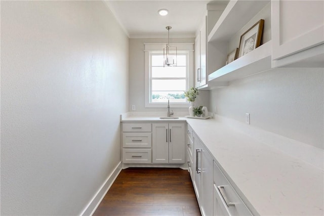 7844 Mathis Creek Dr, Bryan, TX 77808 - interior space with dark wood-style flooring, decorative light fixtures, crown molding, a sink, and baseboards