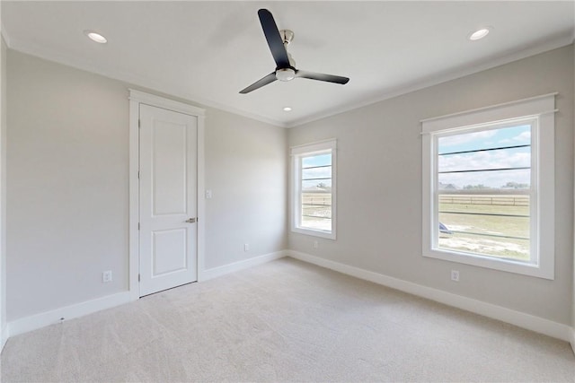 7844 Mathis Creek Dr, Bryan, TX 77808 - spare room with crown molding, a ceiling fan, baseboards, and light colored carpet