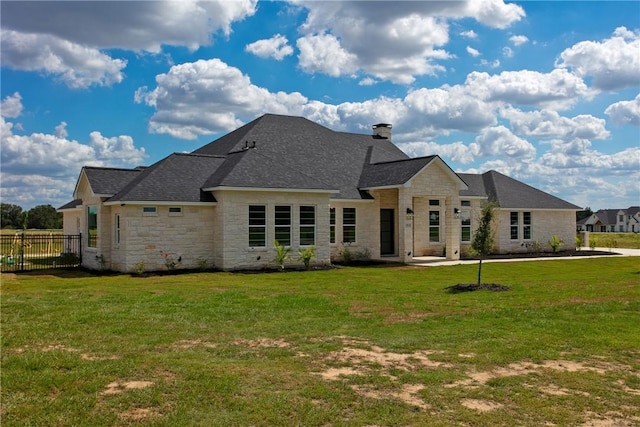 7844 Mathis Creek Dr, Bryan, TX 77808 - french country inspired facade featuring fence, a chimney, a front yard, and stone siding
