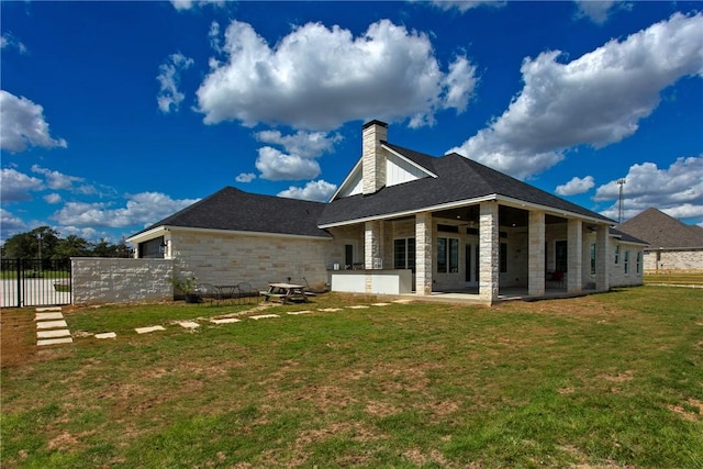 7844 Mathis Creek Dr, Bryan, TX 77808 - back of property with fence, stone siding, a chimney, a patio area, and a lawn