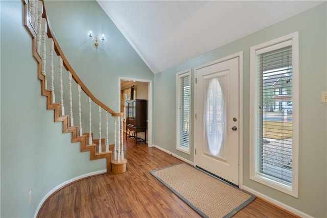 foyer featuring hardwood / wood-style floors and vaulted ceiling