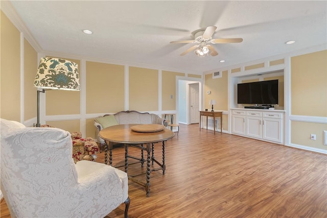 interior space featuring crown molding, ceiling fan, and light wood-type flooring