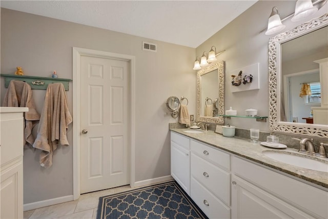 bathroom with tile patterned flooring and vanity