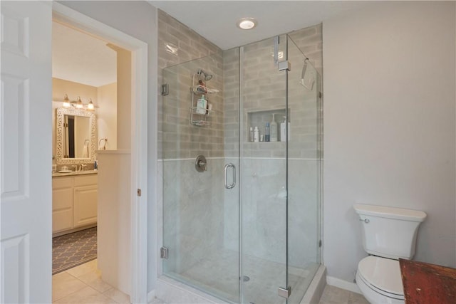 bathroom with vanity, an enclosed shower, tile patterned floors, and toilet