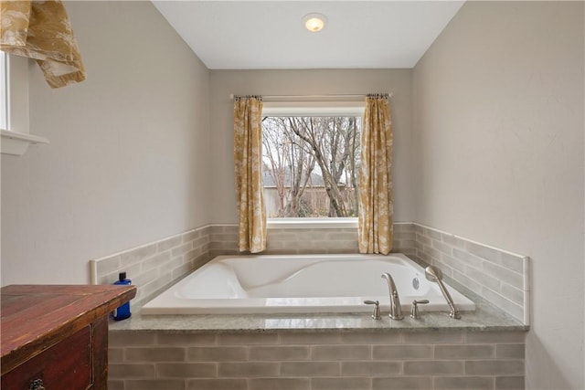 bathroom with tiled bath