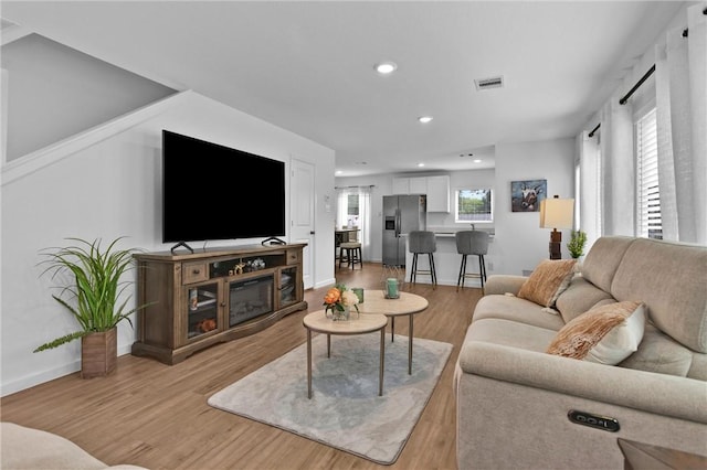 317 Riverwood Village Ln, Sealy, TX 77474 - living room featuring light wood-style floors, recessed lighting, and baseboards
