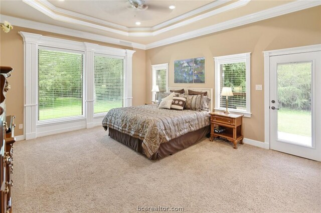 carpeted bedroom featuring a tray ceiling, access to exterior, ceiling fan, and crown molding