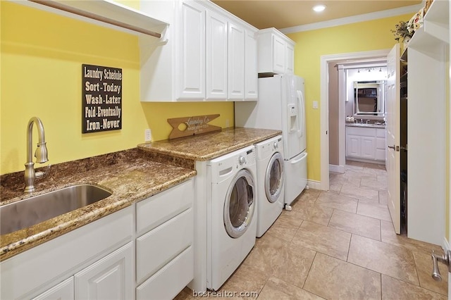 clothes washing area featuring washer and clothes dryer, cabinets, sink, ornamental molding, and light tile patterned floors