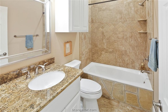 full bathroom featuring vanity, tiled shower / bath combo, and toilet