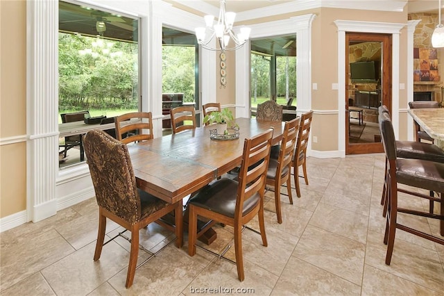 tiled dining room featuring a fireplace and a notable chandelier