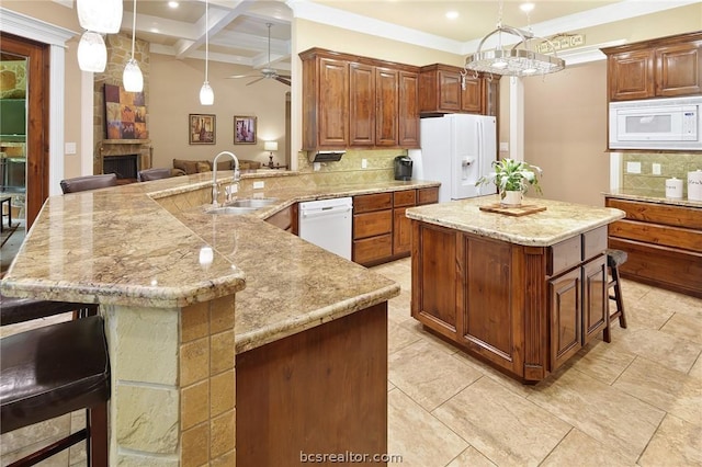 kitchen featuring a kitchen breakfast bar, tasteful backsplash, white appliances, ceiling fan, and sink