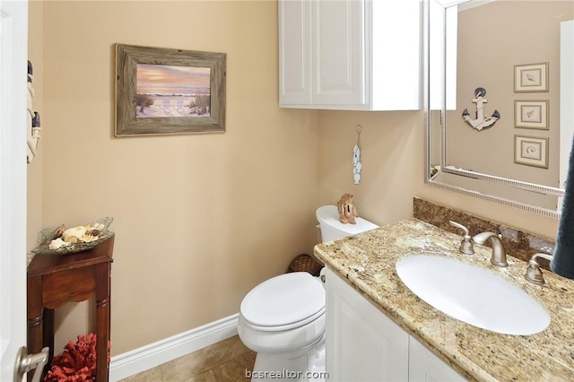 bathroom with tile patterned floors, vanity, and toilet