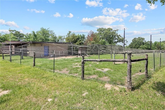 view of yard with a rural view and an outdoor structure