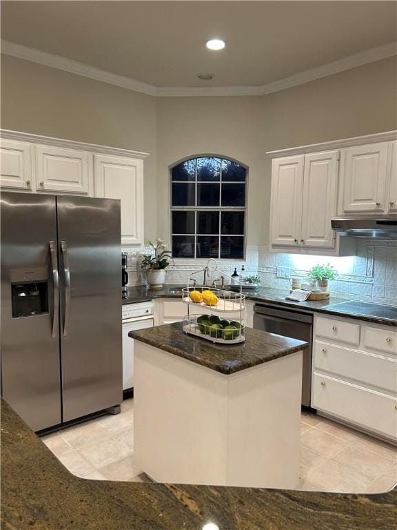 kitchen with decorative backsplash, dark stone counters, black appliances, white cabinets, and a center island