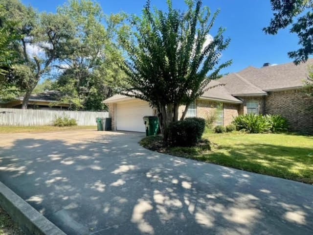 view of property exterior with a garage and a yard