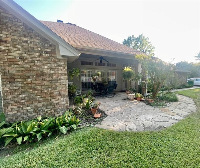 view of yard with a patio area and ceiling fan