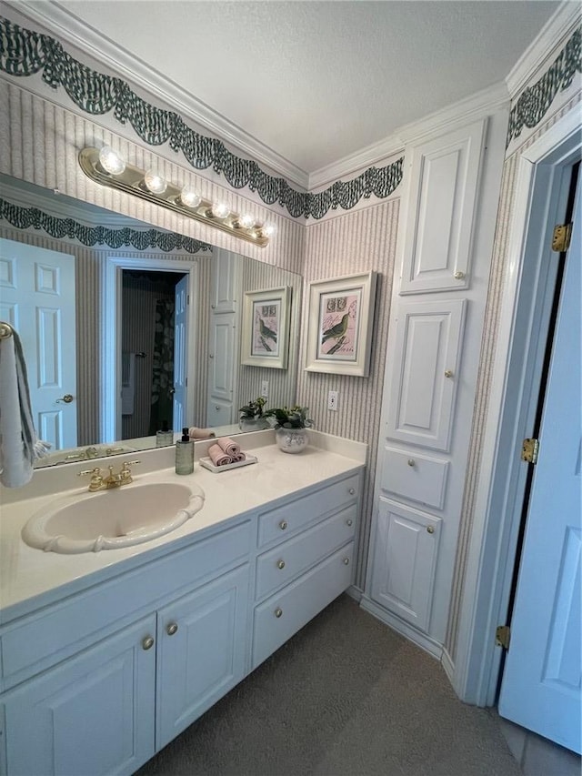 bathroom with a textured ceiling, crown molding, and vanity