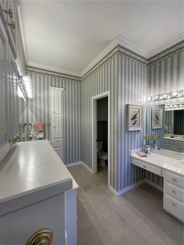 bathroom featuring toilet, vanity, tile patterned floors, and crown molding