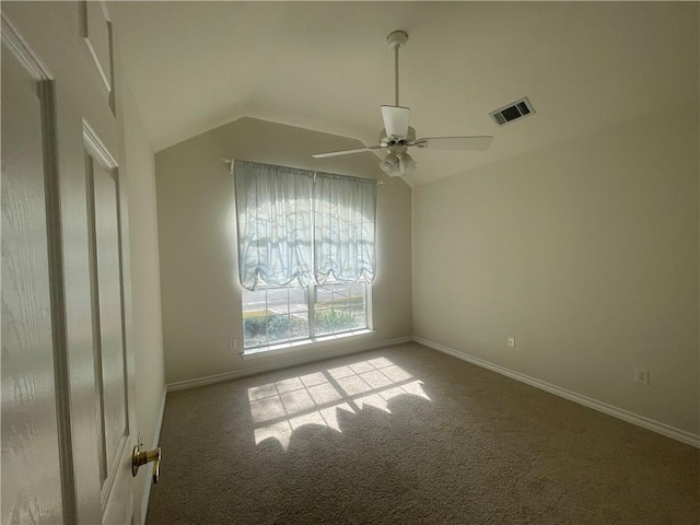 empty room with ceiling fan, carpet, and lofted ceiling