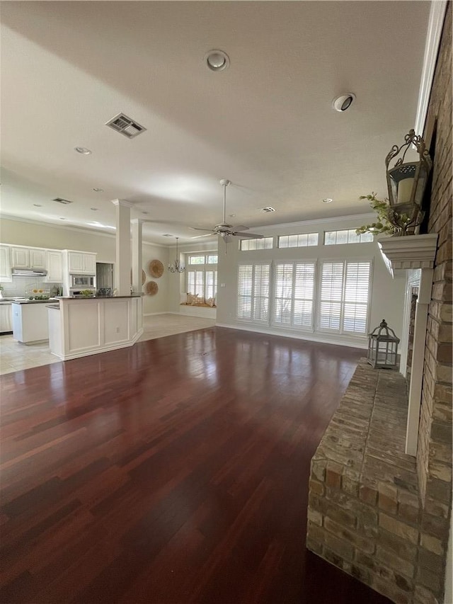 living room featuring ceiling fan, a fireplace, plenty of natural light, and hardwood / wood-style floors