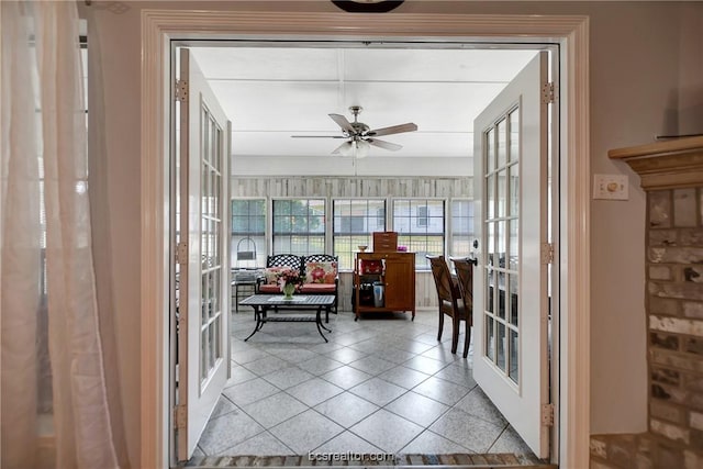 sunroom with ceiling fan and french doors