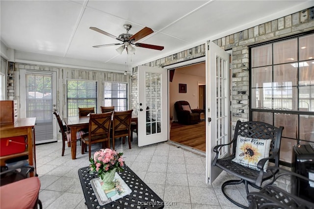 sunroom / solarium featuring ceiling fan and french doors