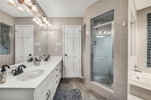 bathroom featuring shower with separate bathtub, vanity, and tile patterned floors