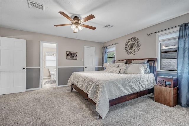 carpeted bedroom featuring ceiling fan and connected bathroom