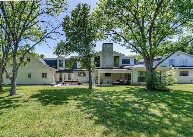 rear view of house with a lawn, a patio, and an outdoor hangout area