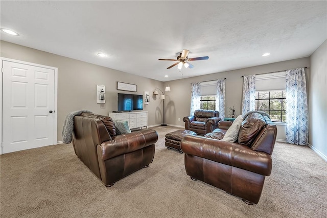 carpeted living room featuring ceiling fan