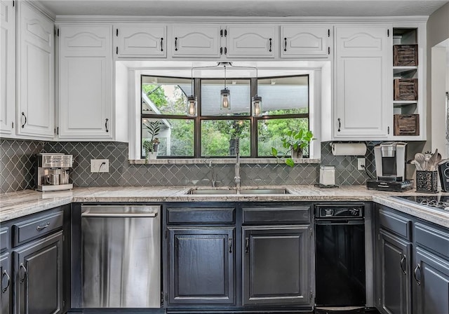 kitchen featuring white cabinets, plenty of natural light, and sink