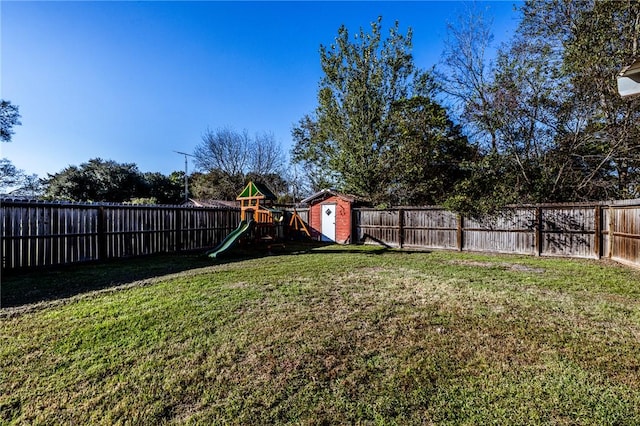 view of yard with a playground and a shed