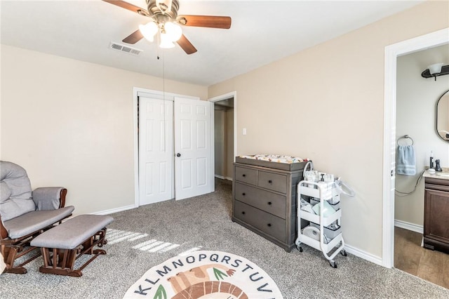 interior space with light carpet, a closet, and ceiling fan