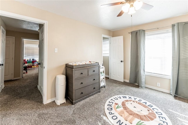 bedroom featuring ceiling fan and carpet