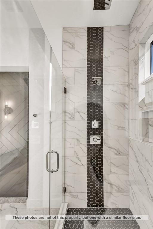 bathroom featuring a shower with door