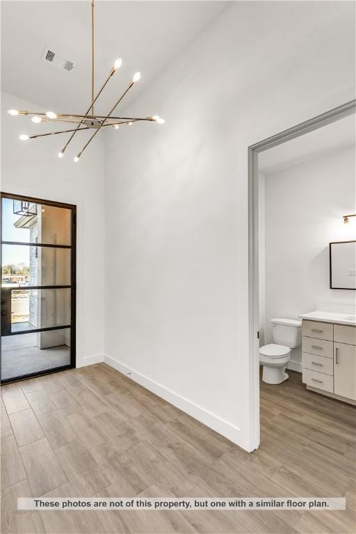 interior space with a chandelier and light wood-type flooring