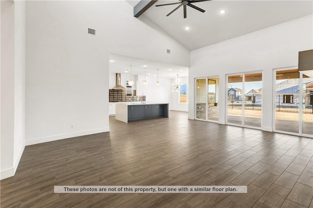 unfurnished living room with ceiling fan, dark hardwood / wood-style floors, and high vaulted ceiling