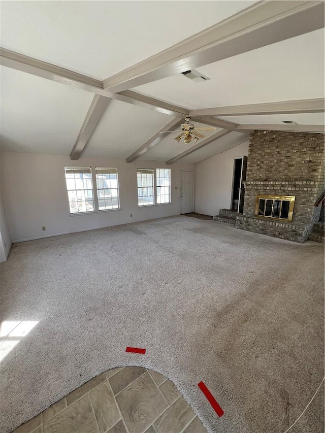 unfurnished living room featuring visible vents, vaulted ceiling with beams, ceiling fan, a brick fireplace, and carpet flooring