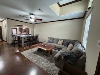 3349 General Pkwy, College Station, TX 77845 - living area with arched walkways, plenty of natural light, a skylight, and ceiling fan