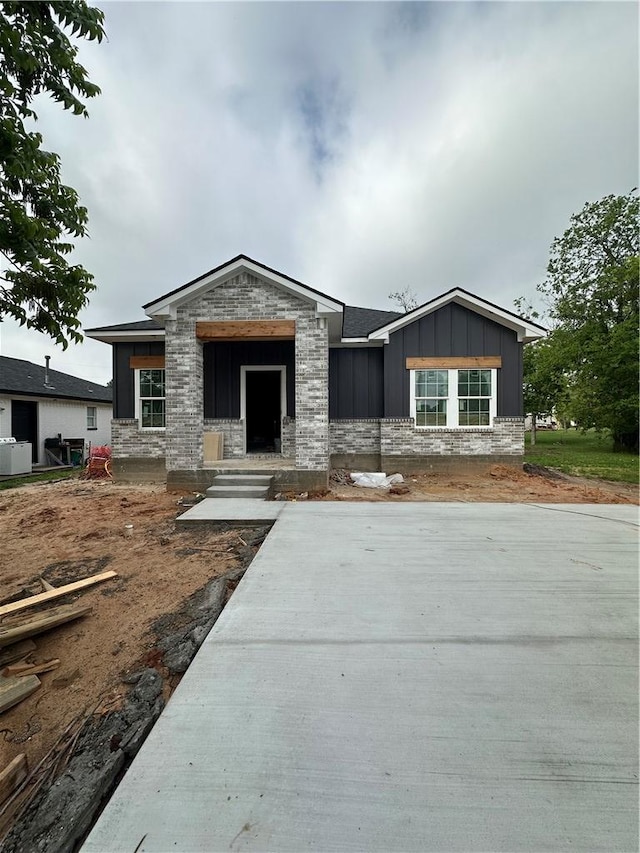 view of front facade with board and batten siding and stone siding