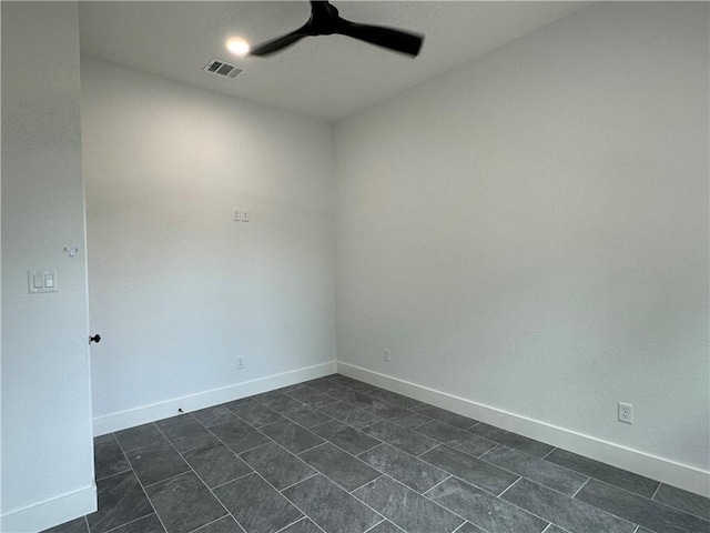 705 Waco St, Bryan, TX 77803 - spare room featuring ceiling fan and dark tile patterned flooring