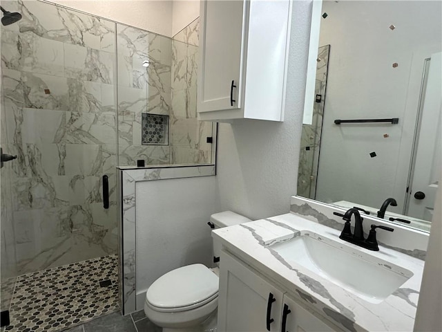 705 Waco St, Bryan, TX 77803 - bathroom featuring a marble finish shower, vanity, and a textured wall