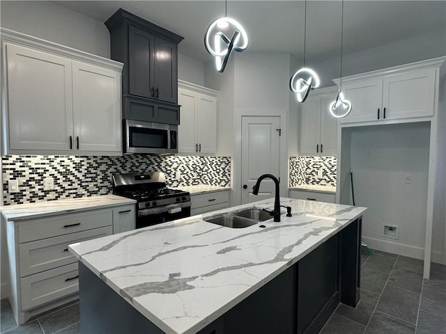 705 Waco St, Bryan, TX 77803 - kitchen with stainless steel microwave, range with gas stovetop, decorative backsplash, an island with sink, and light stone countertops