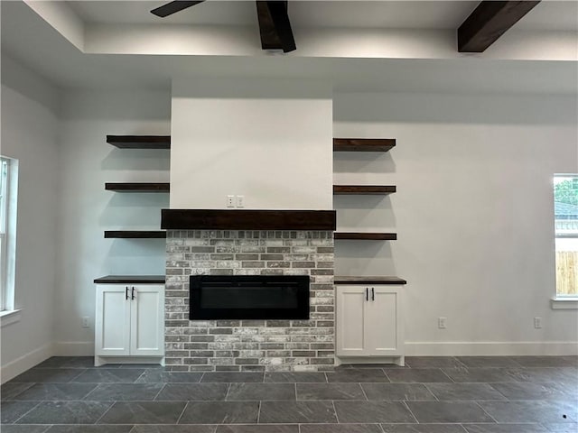 705 Waco St, Bryan, TX 77803 - unfurnished living room with a ceiling fan and beamed ceiling