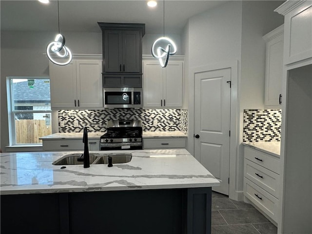 705 Waco St, Bryan, TX 77803 - kitchen with appliances with stainless steel finishes, light stone countertops, backsplash, decorative light fixtures, and recessed lighting